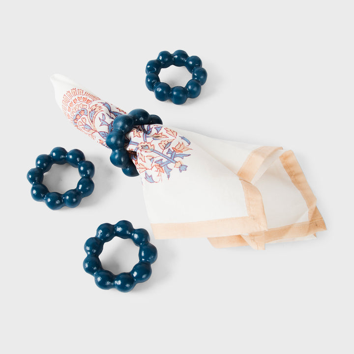Handcrafted terracotta napkin rings styled with linen napkins on an elegant artisan-inspired dining table.