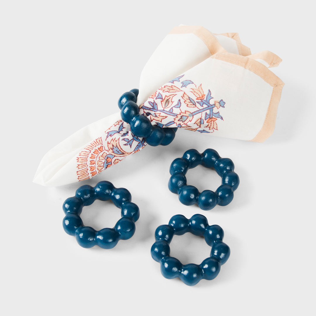 Handcrafted terracotta napkin rings styled with linen napkins on an elegant artisan-inspired dining table.