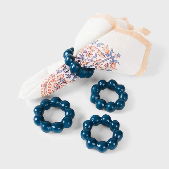Handcrafted terracotta napkin rings styled with linen napkins on an elegant artisan-inspired dining table.