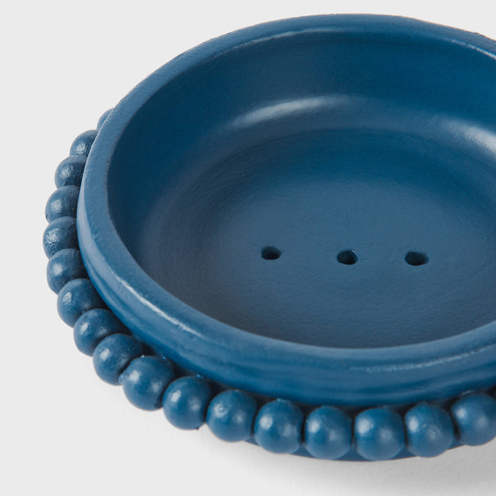 Close-up of the handcrafted terracotta soap dish highlighting its matte indigo glaze and signature raised beaded border.