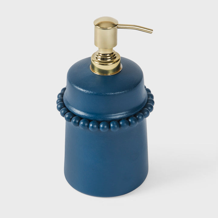 Handcrafted matte indigo terracotta liquid soap dispenser with raised beaded detailing and brushed gold metal pump by Mela Artisans.
