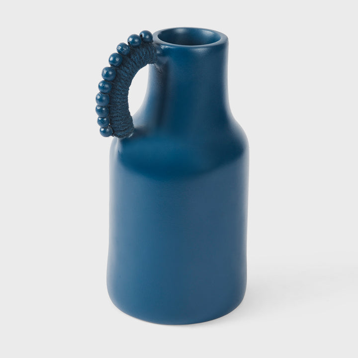 Handcrafted matte indigo terracotta pitcher with a sculptural beaded handle wrapped in tonal cord by Mela Artisans.
