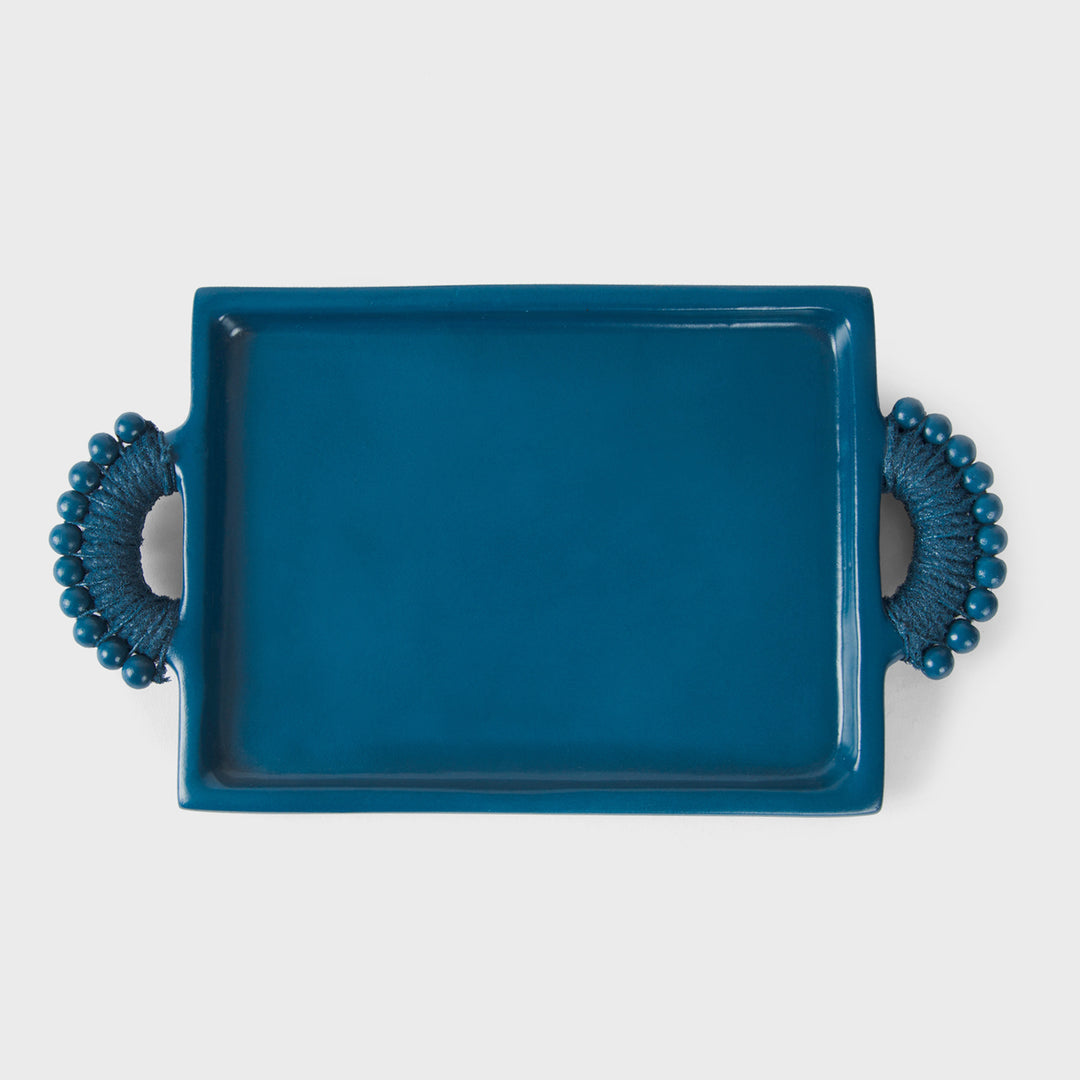 Handcrafted matte indigo terracotta rectangular serving tray with sculptural beaded rope-wrapped handles by Mela Artisans.