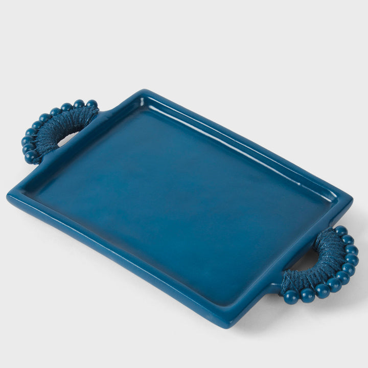 Handcrafted matte indigo terracotta rectangular serving tray with sculptural beaded rope-wrapped handles by Mela Artisans.