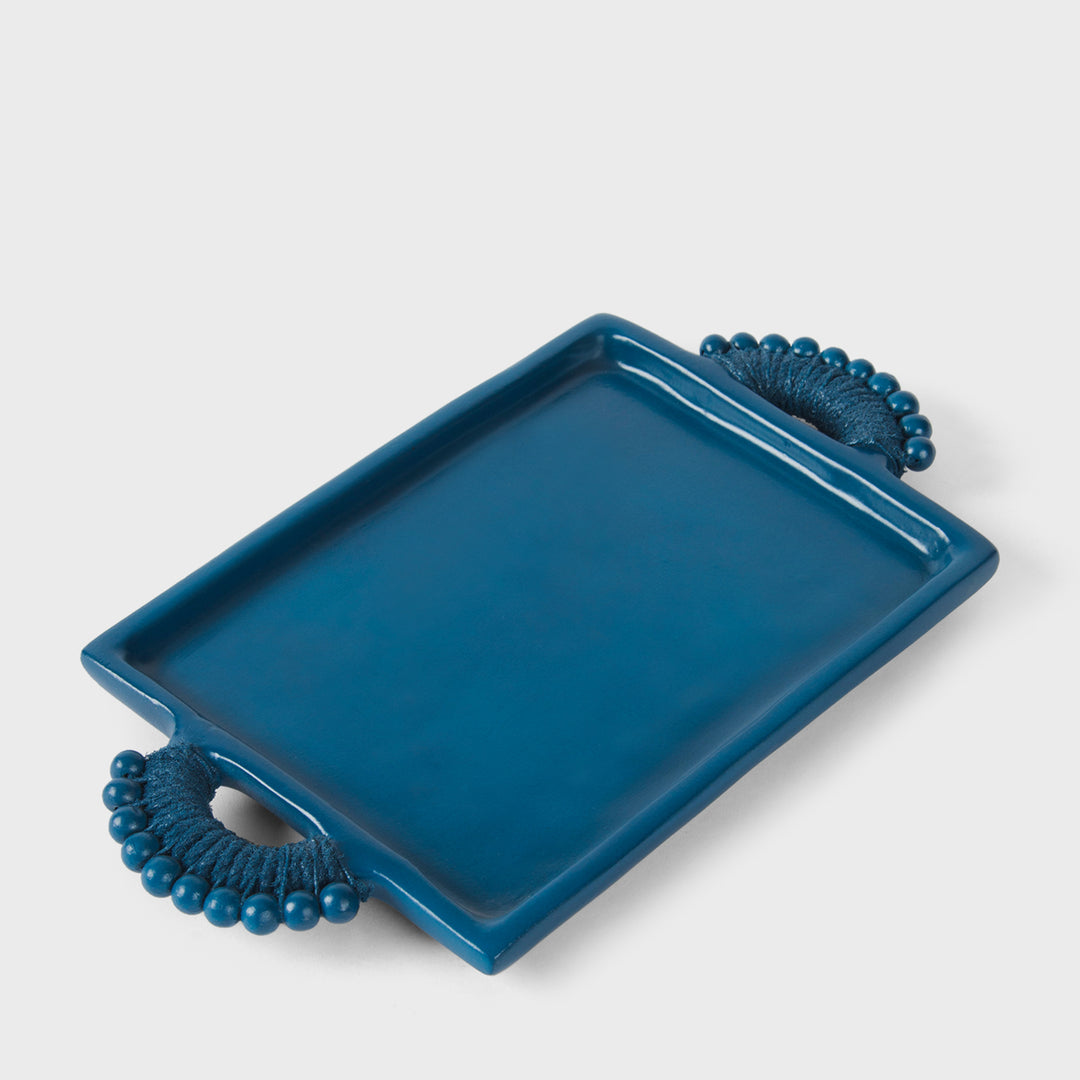 Handcrafted matte indigo terracotta rectangular serving tray with sculptural beaded rope-wrapped handles by Mela Artisans.