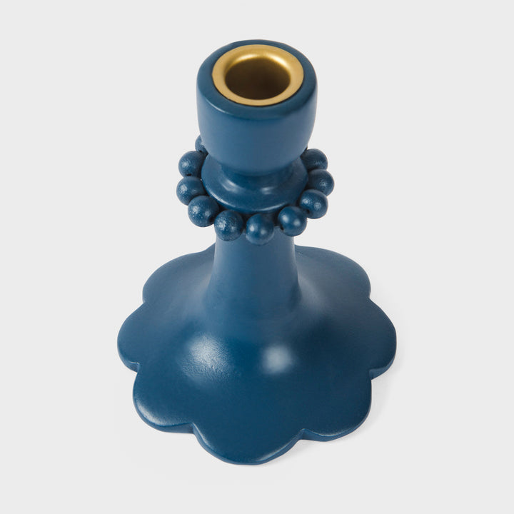 Close-up of the handcrafted terracotta 6" candle holder showcasing the matte indigo glaze, raised bead accents, and sculptural scalloped base.