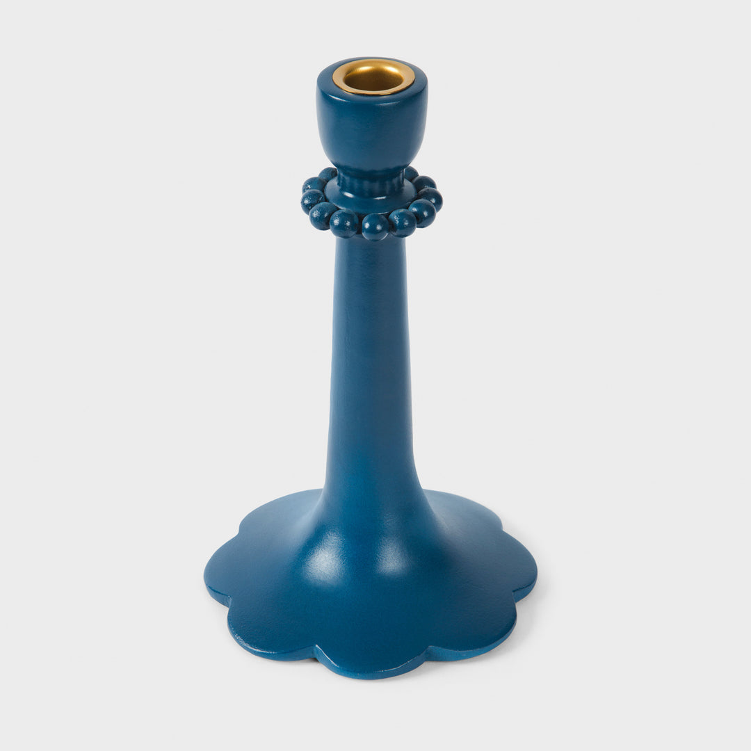 Close-up of the handcrafted terracotta 9" candle holder showcasing the matte indigo glaze, raised bead accents, and sculptural scalloped base.