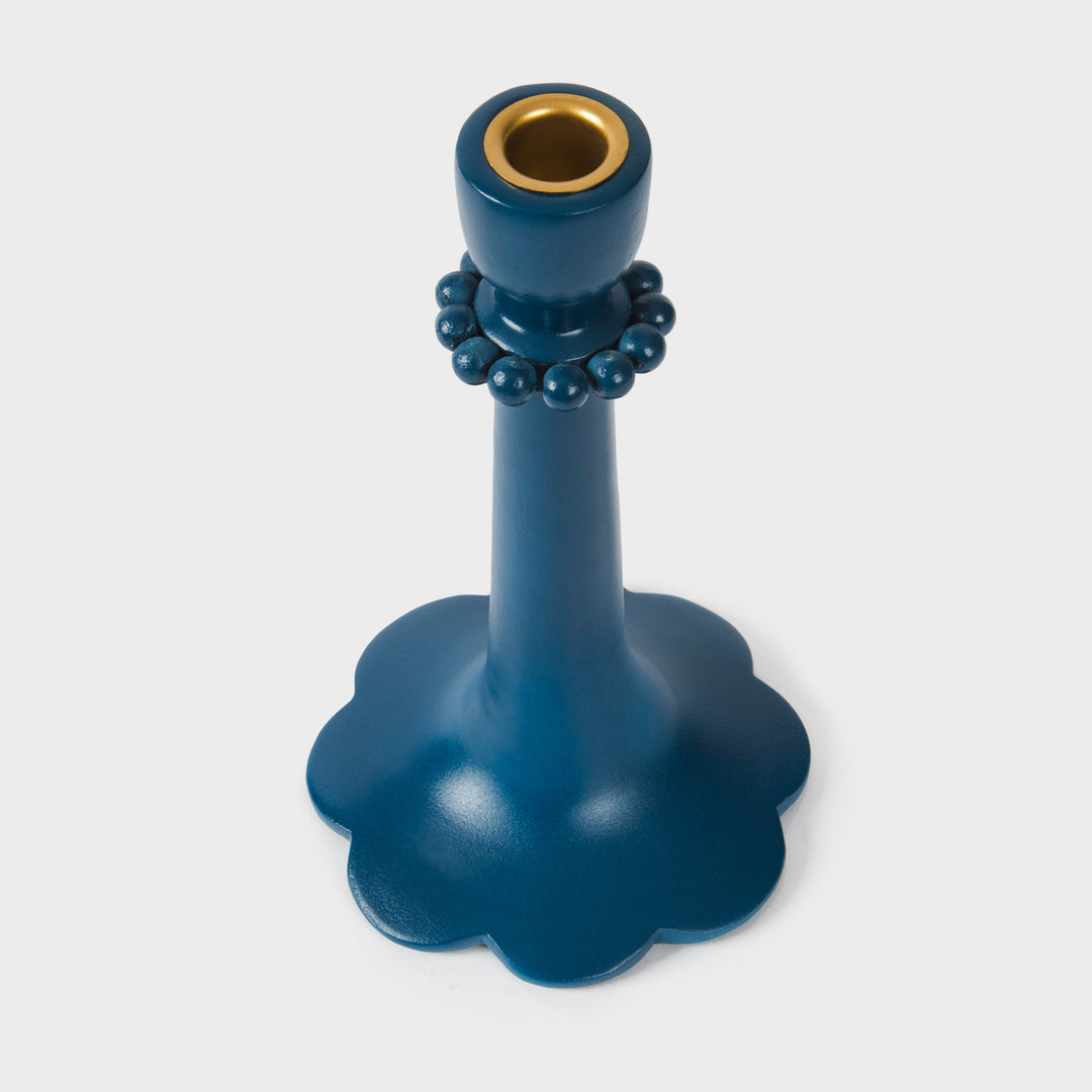 Close-up of the handcrafted terracotta 9" candle holder showcasing the matte indigo glaze, raised bead accents, and sculptural scalloped base.