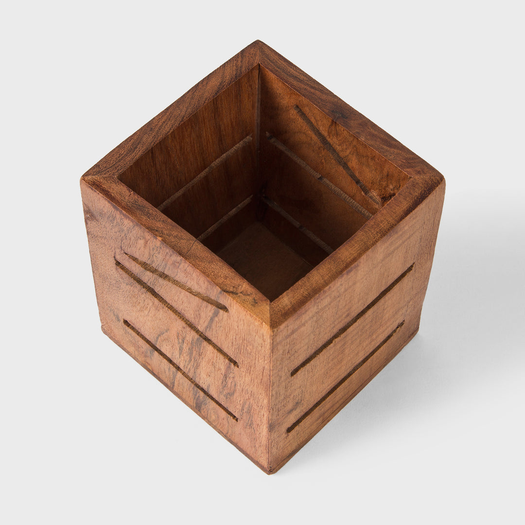 Close-up of smooth natural acacia wood grain texture and geometric carved slots