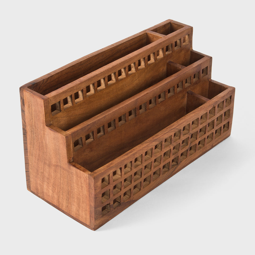 Close-up of grid cutout pattern and natural acacia wood grain texture