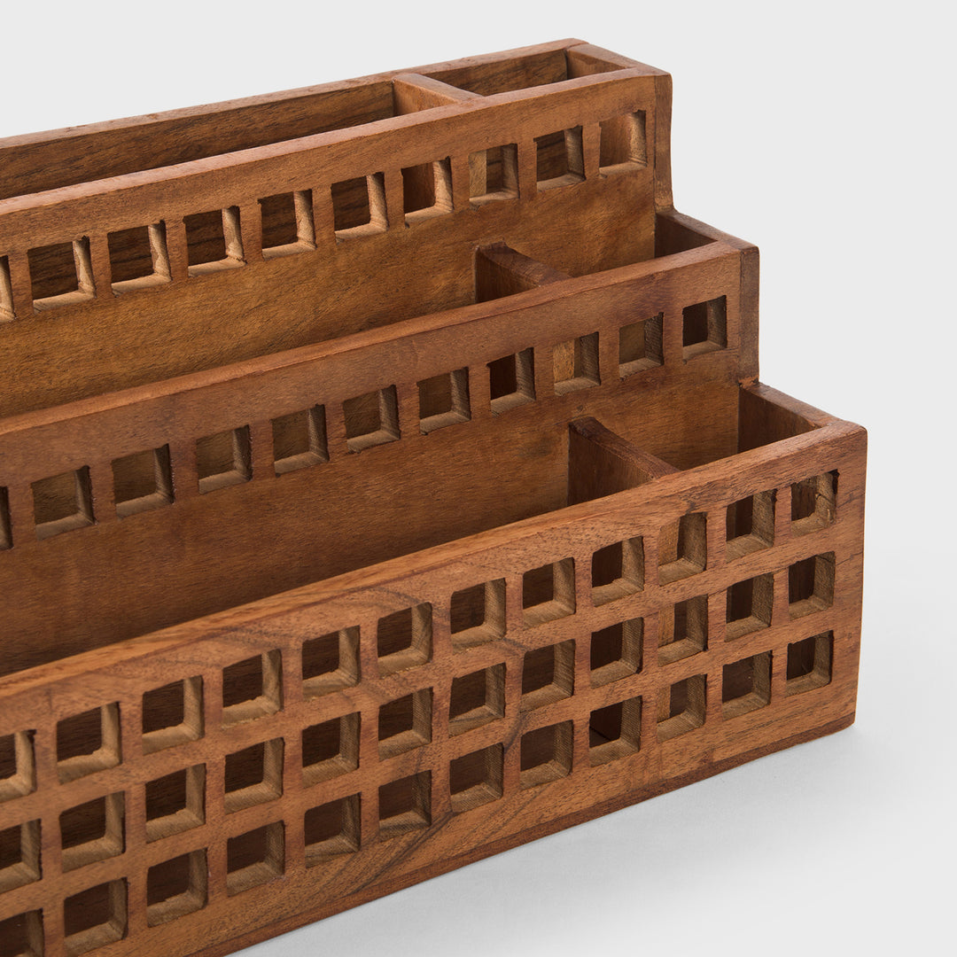 Close-up of grid cutout pattern and natural acacia wood grain texture