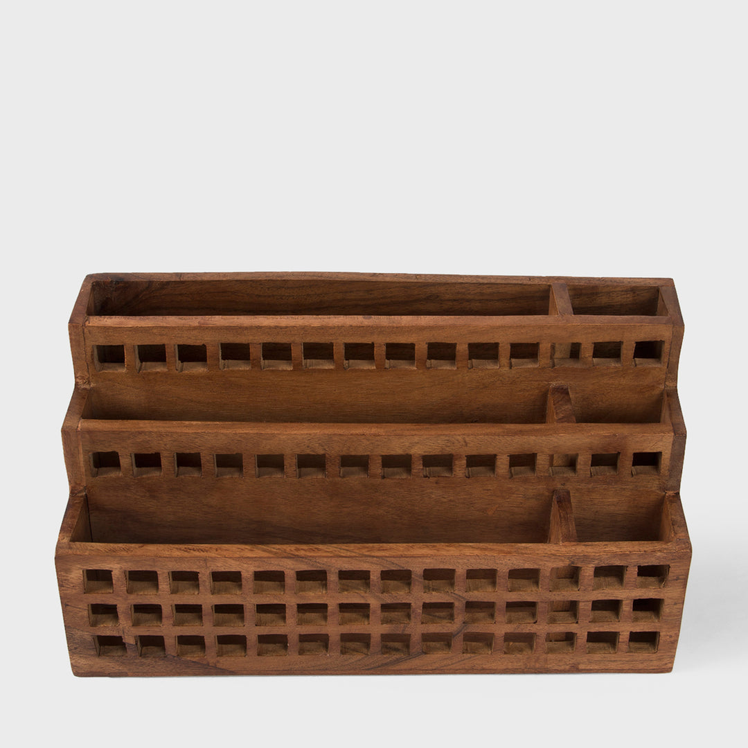 Close-up of grid cutout pattern and natural acacia wood grain texture