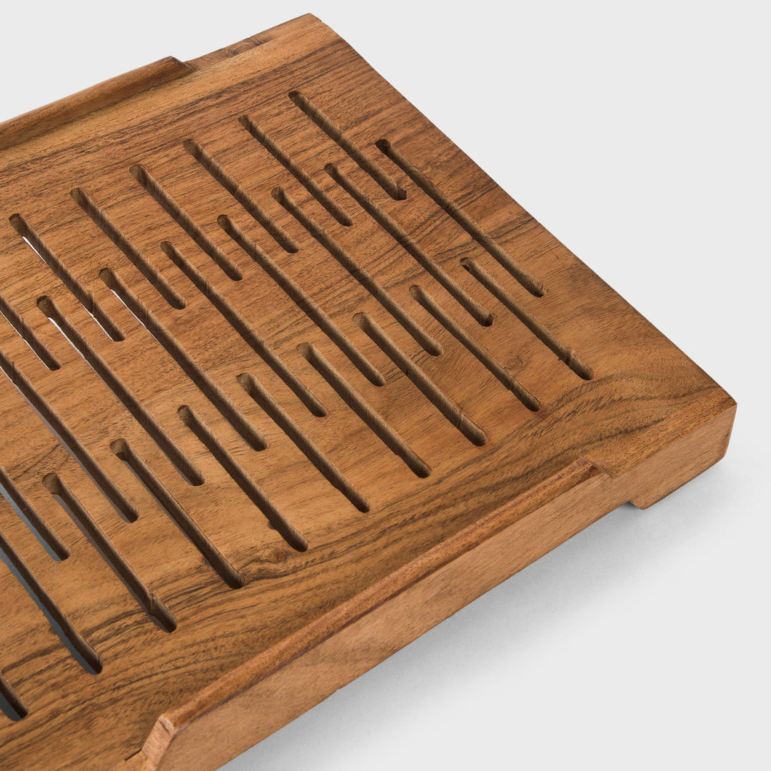 Close-up of smooth natural acacia wood grain texture and carved ventilation slots 