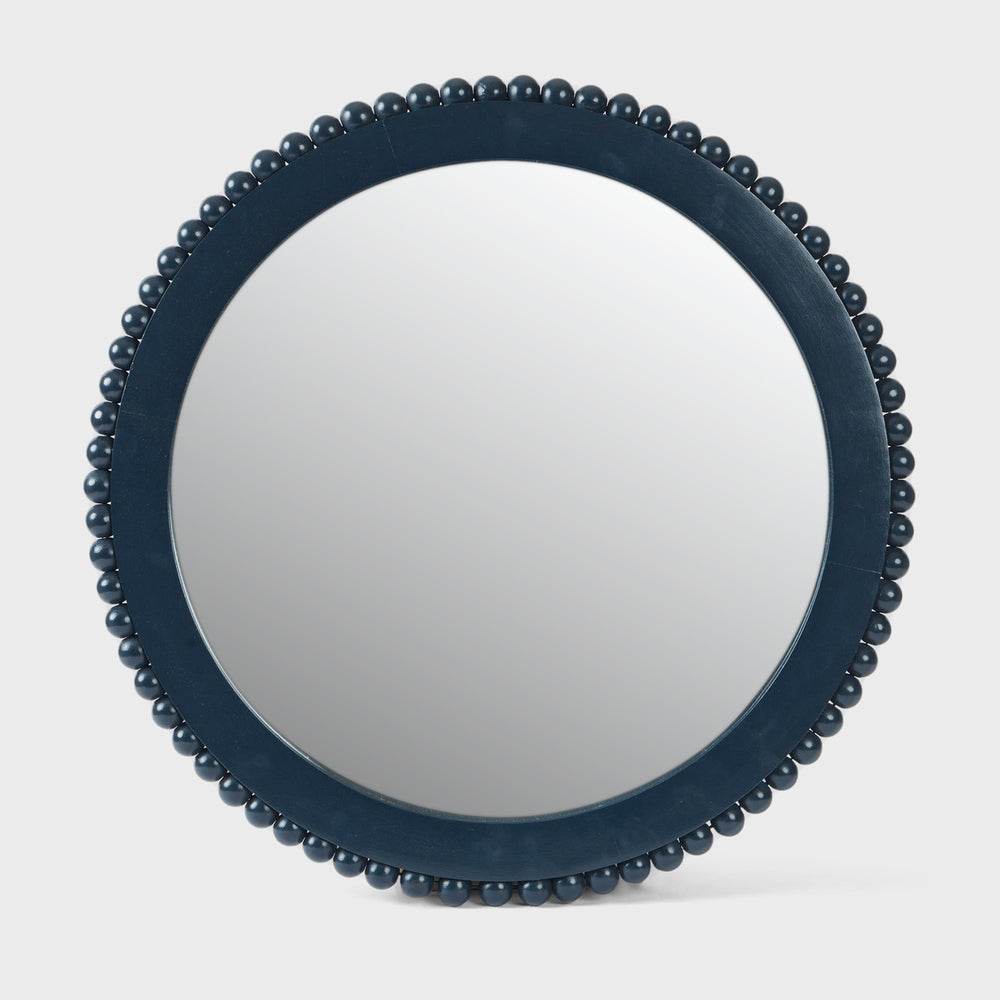 Handcrafted matte indigo round mango wood wall mirror with a hand-carved beaded frame by Mela Artisans.