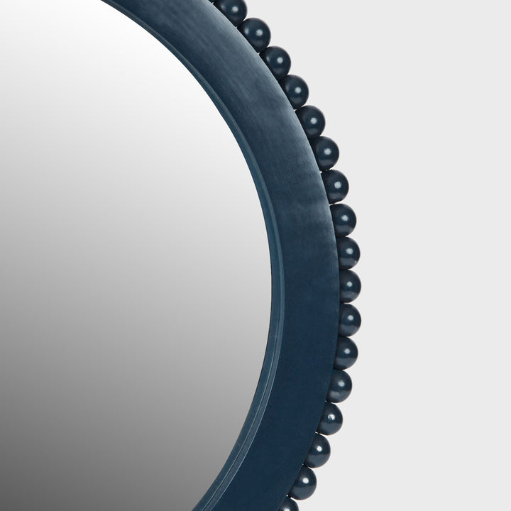 Close-up of the handcrafted mango wood wall mirror showcasing the matte indigo finish, hand-carved beaded border, and premium mirrored glass.