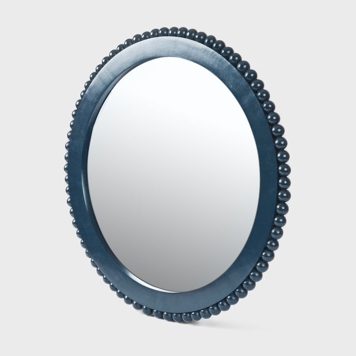 Handcrafted matte indigo round mango wood wall mirror with a hand-carved beaded frame by Mela Artisans.