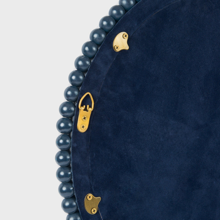Close-up of the handcrafted mango wood wall mirror showcasing the matte indigo finish, hand-carved beaded border, and premium mirrored glass.