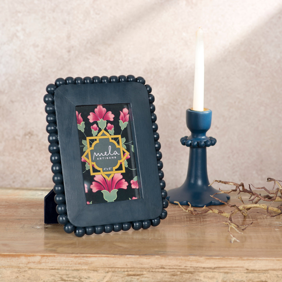 Handcrafted indigo mango wood 4 x 6 photo frame displayed on a console table with a favorite family photograph and coordinating artisan décor.