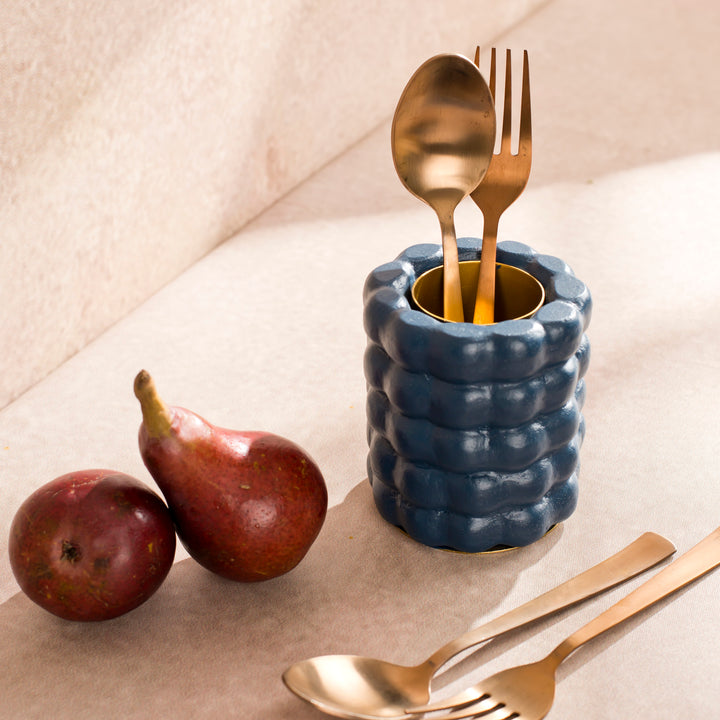 Handcrafted terracotta utility holder styled with gold flatware on a dining table, showcasing artisan craftsmanship and functional tabletop storage.