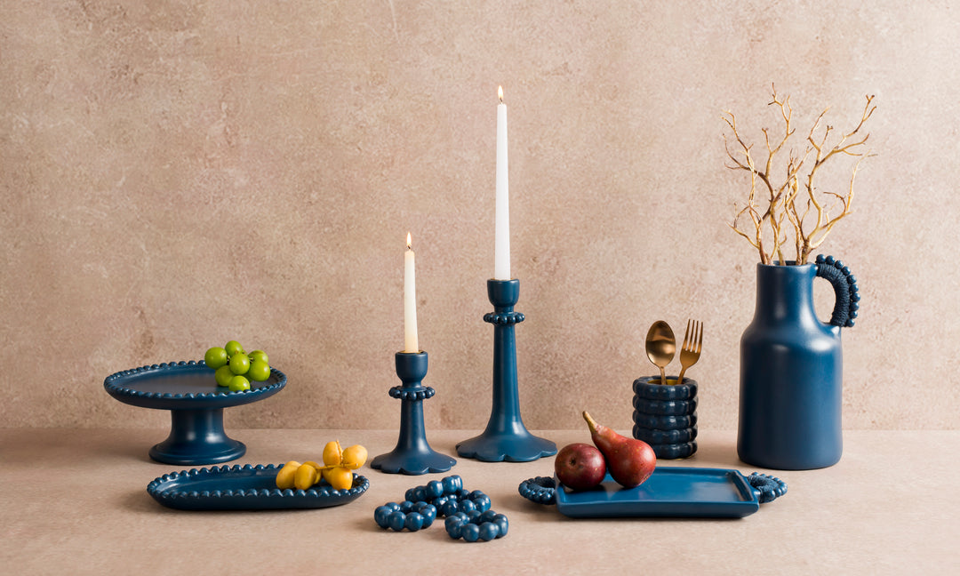 Handcrafted terracotta pedestal cake stand styled with desserts and artisan table décor for an elegant dining presentation.