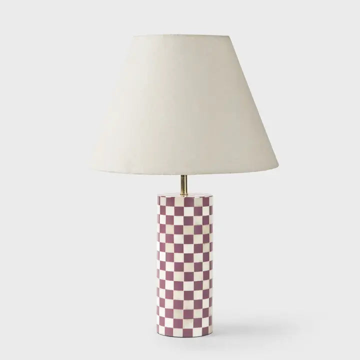 Handcrafted lamp base styled with neutral lampshade on side table