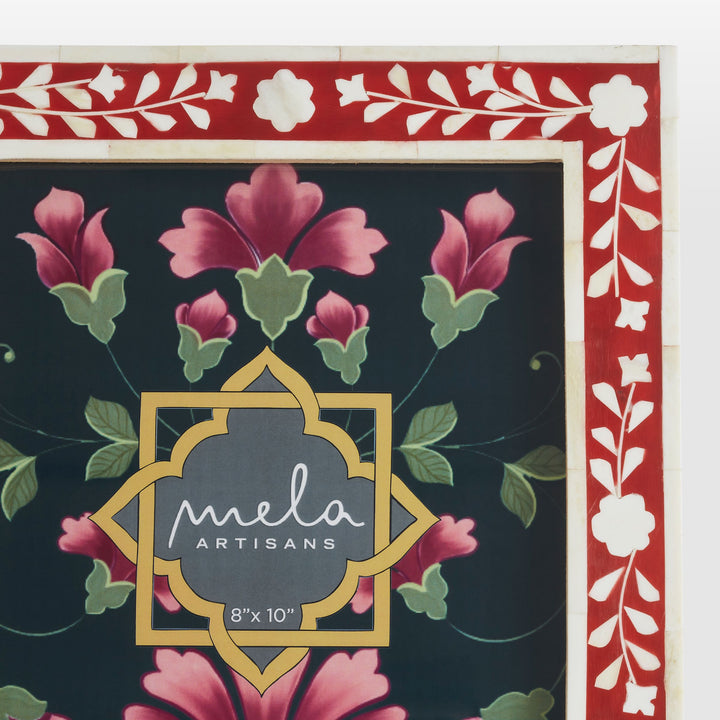 Close-up of handcrafted ivory floral bone inlay pattern set in deep crimson-red resin 