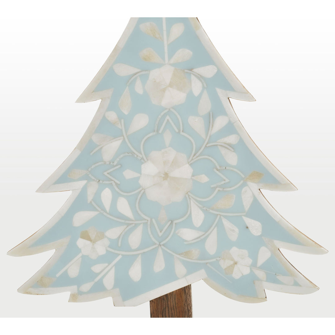 Close-up of handcrafted ivory floral bone inlay pattern set in vibrant teal resin 