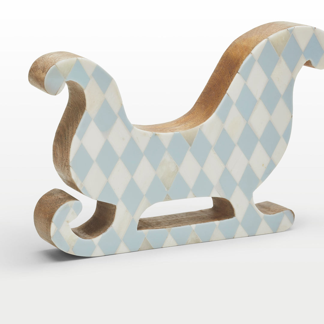 Close-up of handcrafted teal resin and white bone inlay diamond pattern on the sleigh contour 