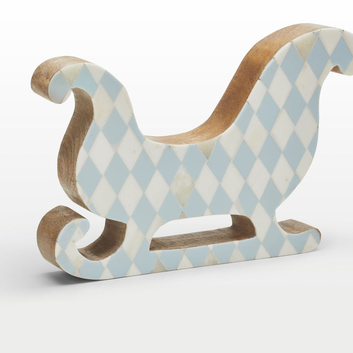 Close-up of handcrafted teal resin and white bone inlay diamond pattern on the sleigh contour 