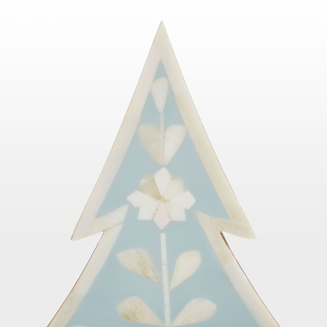Close-up of handcrafted ivory floral bone inlay pattern set in vibrant teal resin 