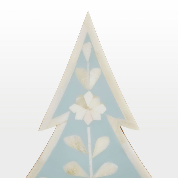 Close-up of handcrafted ivory floral bone inlay pattern set in vibrant teal resin 
