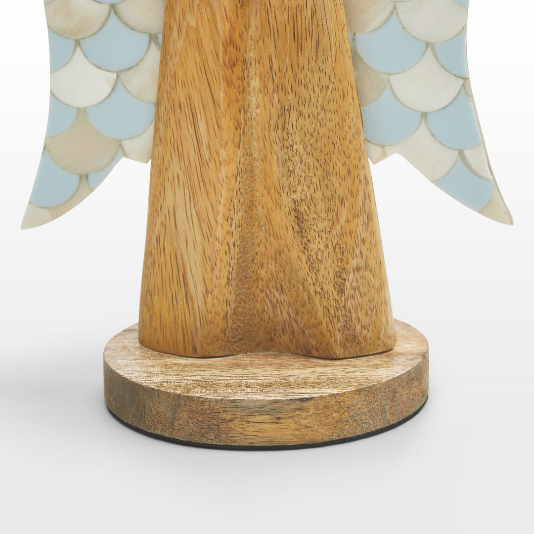 Close-up of hand-carved wooden angel body and scalloped teal and white bone inlay wing pattern