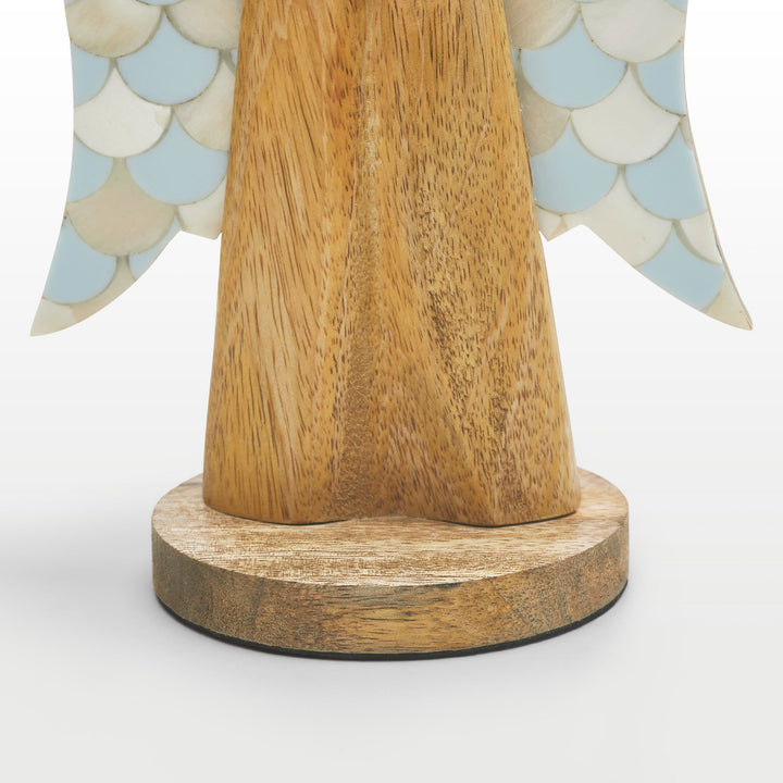 Close-up of hand-carved wooden angel body and scalloped teal and white bone inlay wing pattern