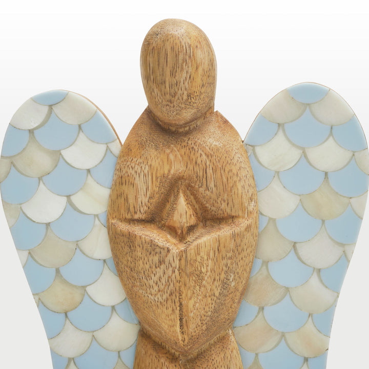 Close-up of hand-carved wooden angel body and scalloped teal and white bone inlay wing pattern