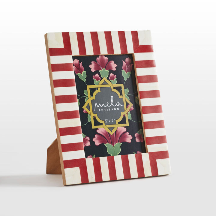 Close-up of handcrafted red resin and white bone inlay striped pattern texture