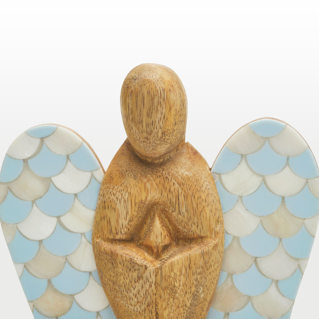 Close-up of hand-carved wooden angel body and scalloped teal and white bone inlay wing pattern