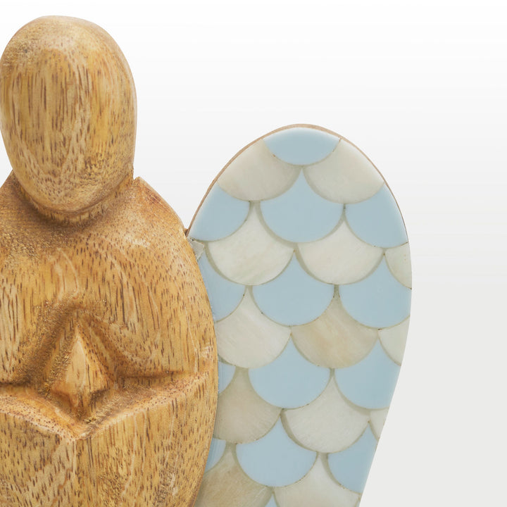 Close-up of hand-carved wooden angel body and scalloped teal and white bone inlay wing pattern