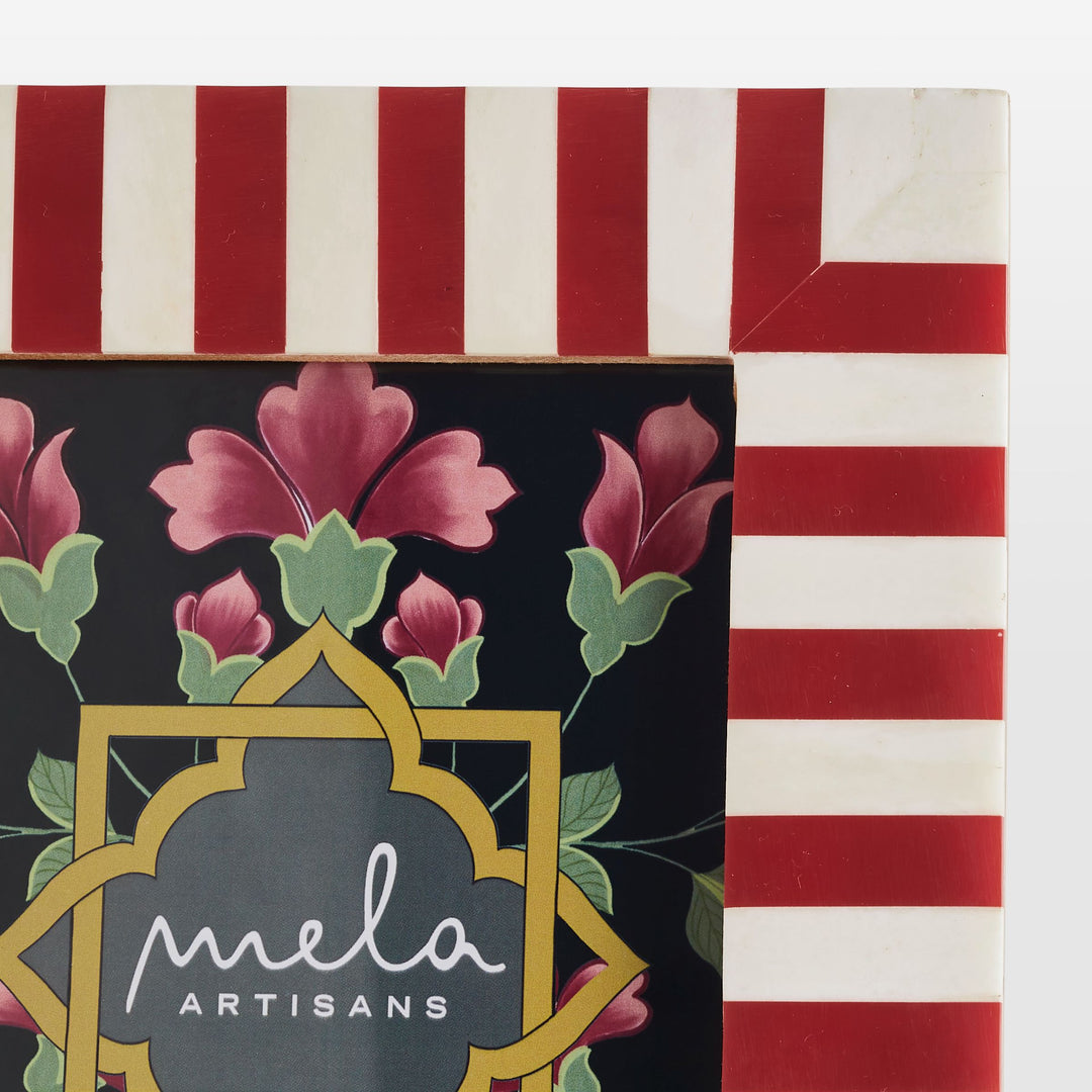 Close-up of handcrafted red resin and white bone inlay striped pattern texture