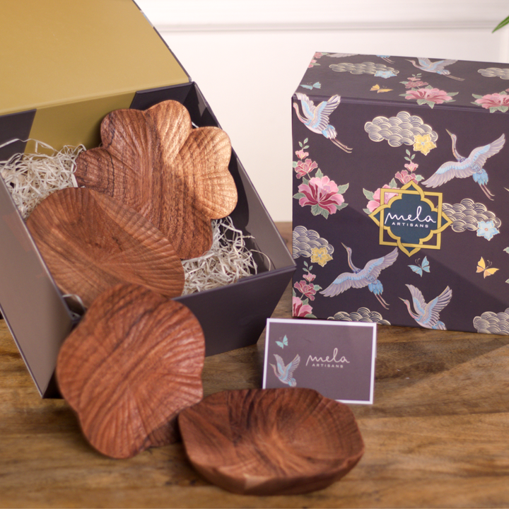 Set of four handcrafted wooden trinket trays in assorted carved shapes
