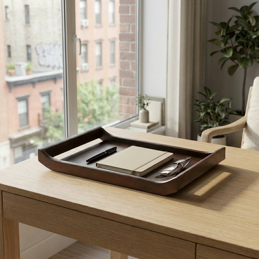 Stacked acacia wood serving trays styled on coffee table with drinks and snacks