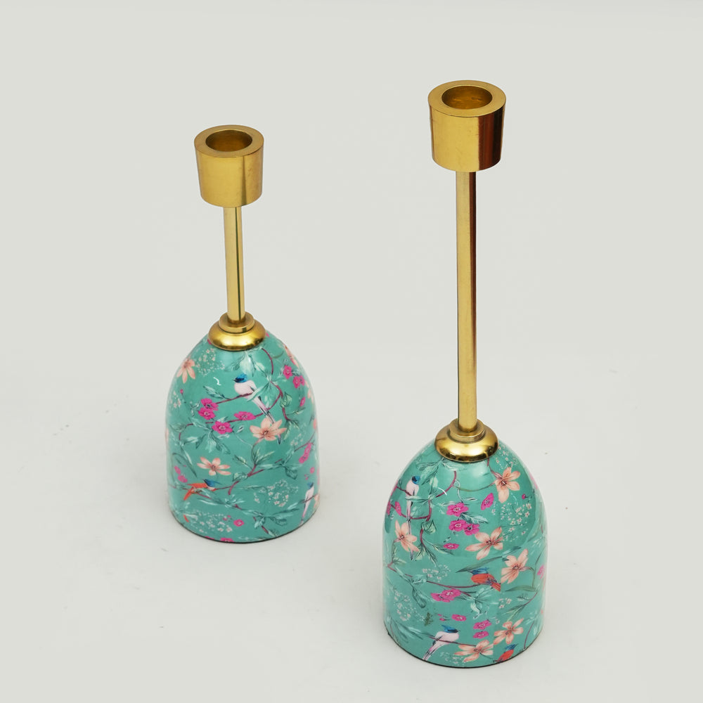 Pair of Aqua Flora tapered candleholders with turquoise floral enamel bases and gold-toned metal stems.