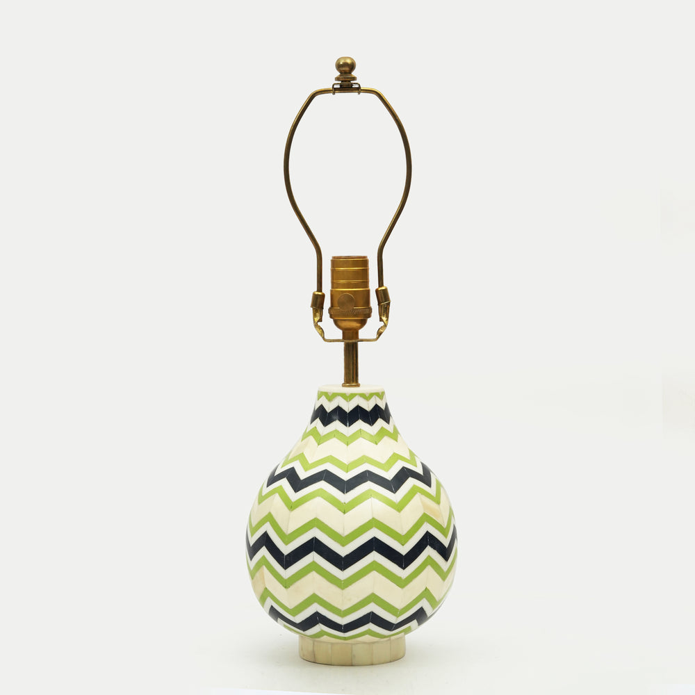 Chevron bone inlay lamp with a pleated yellow shade styled on a wooden nightstand for a cozy bedroom look.
