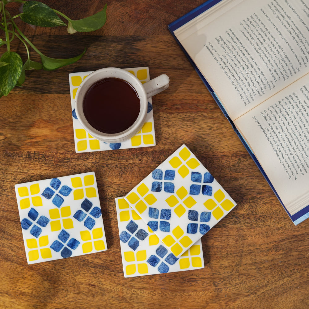 decorative yellow bone inlay coasters on coffee table with drinks