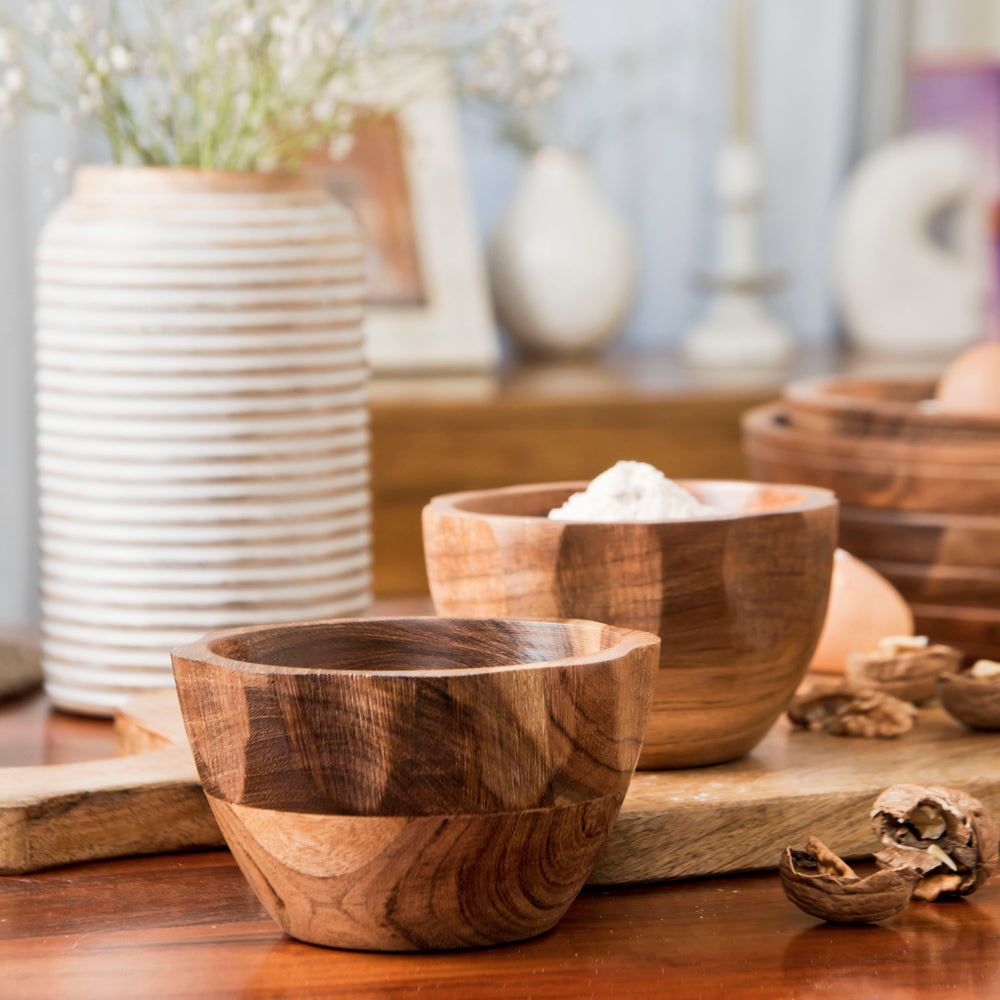 Wooden bowls styled with snacks on a dining or coffee table
