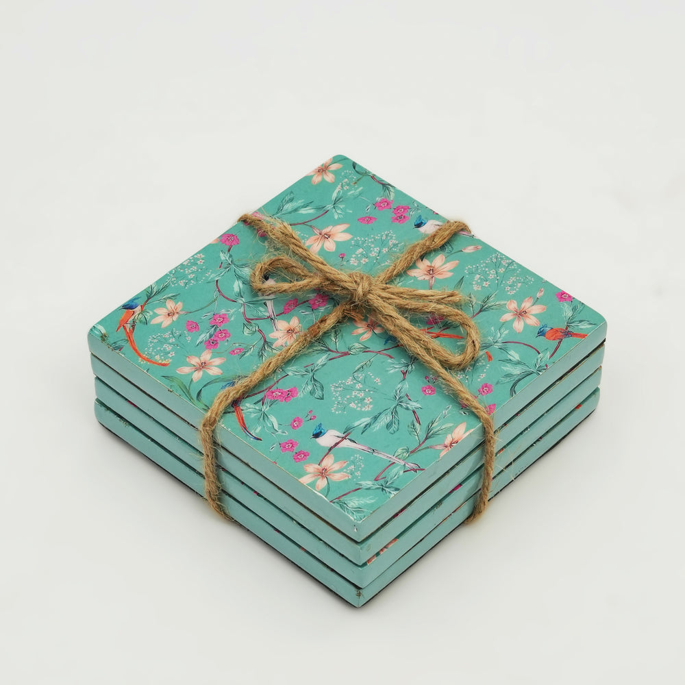 Set of floral coasters tied with twine on a light gray background