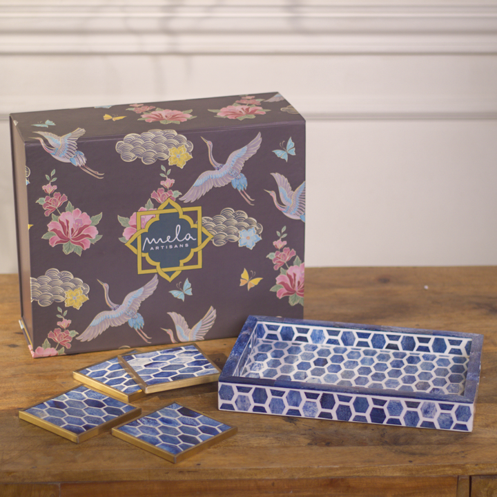 Tray and coaster set styled on coffee table with beverages during a gathering
