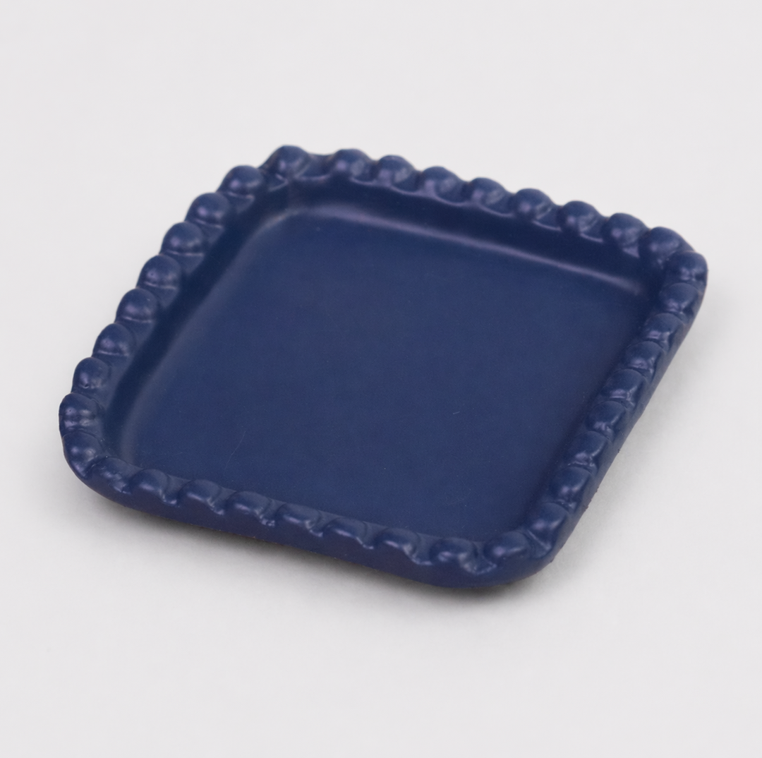  Close-up of beaded edge design and indigo finish on handcrafted terracotta tray