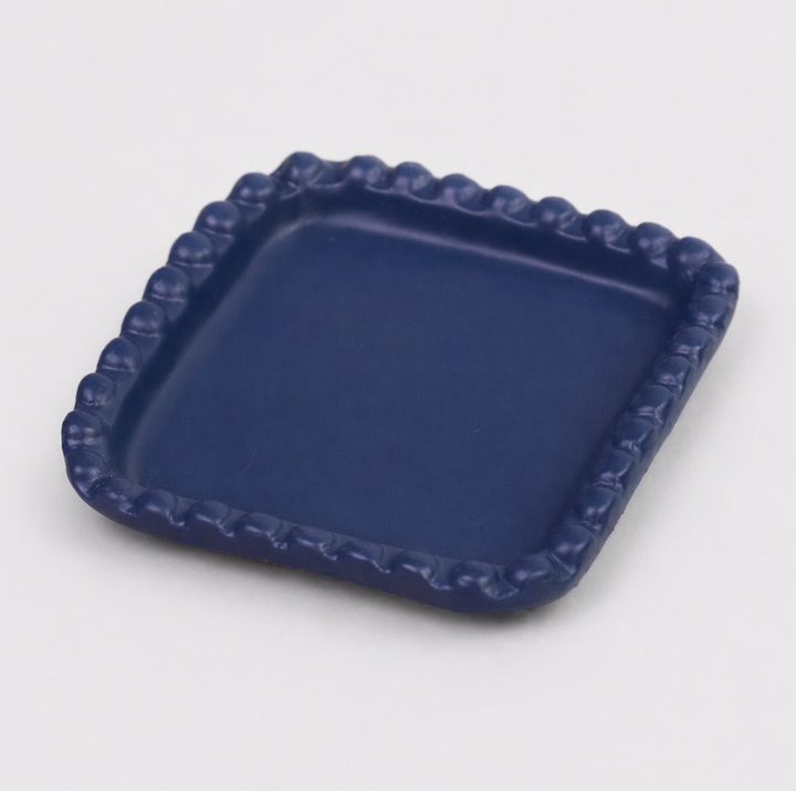  Close-up of beaded edge design and indigo finish on handcrafted terracotta tray