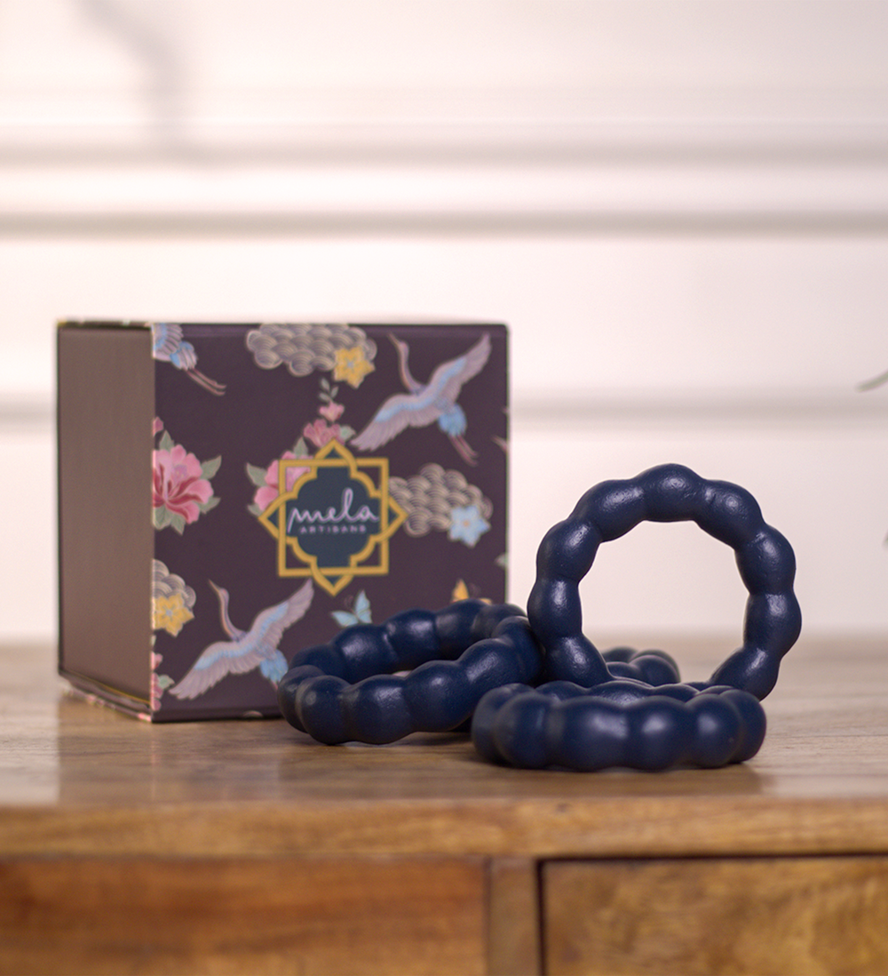  Close-up of handcrafted beaded detailing on terracotta napkin ring