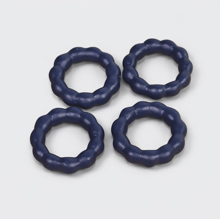  Beaded terracotta napkin rings styled on a festive dining table with cloth napkins
